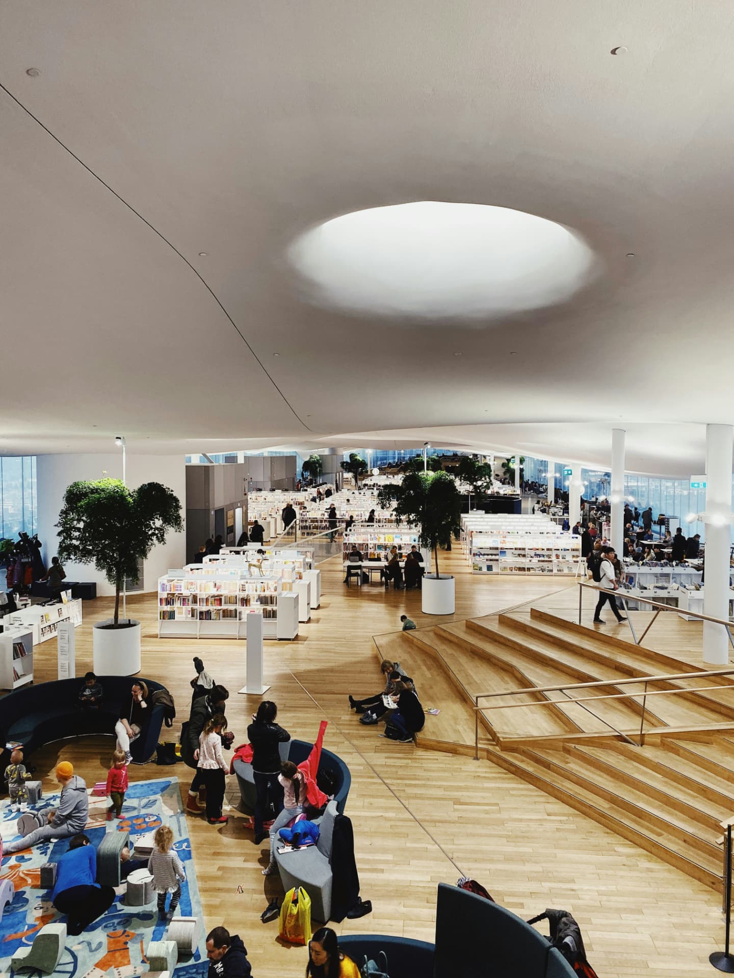The open timber reading floor of Oodi central library in Helsinki