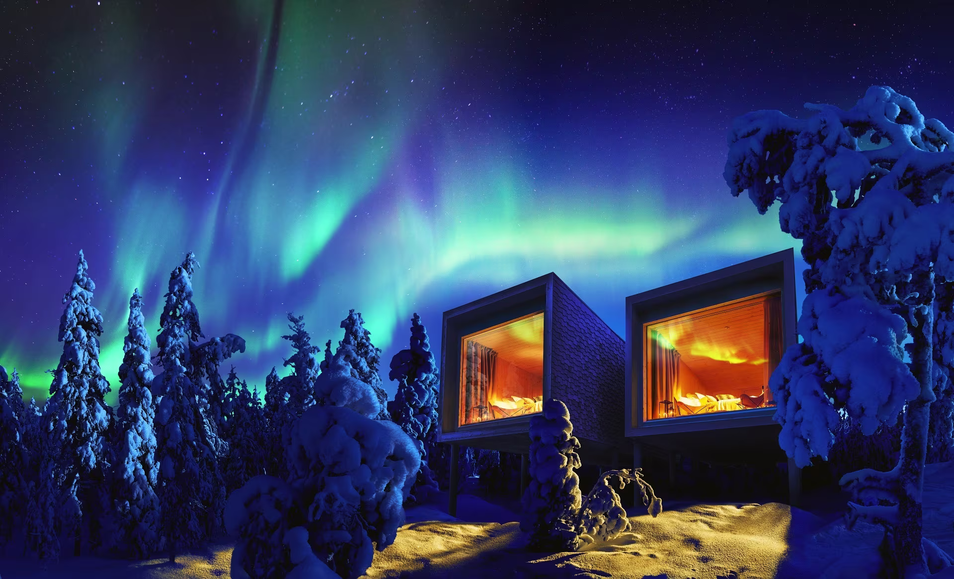 Arctic TreeHouse Hotel suites on a snowy forest slope in Rovaniemi at dusk