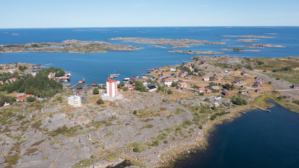 Aerial view of a lighthouse island village on bare granite in the outer archipelago
